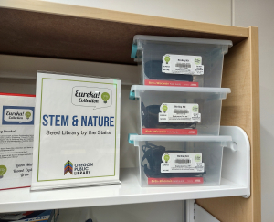 Shelf with small plastic boxes on it with birding kits inside